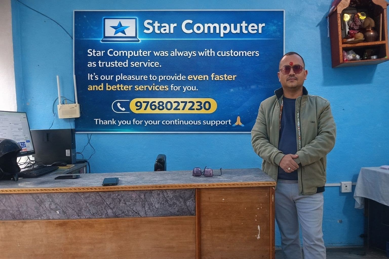 Tej Prakash GC standing beside the Star Computer sign at the institute