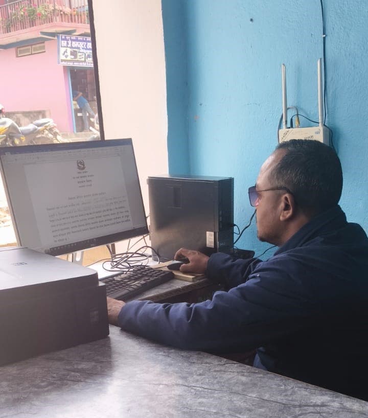 Tej Prakash GC preparing an official document on a computer
